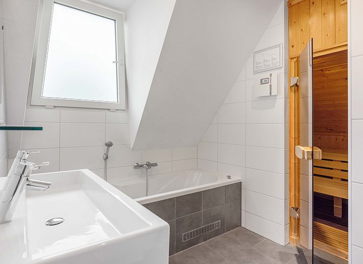 Cozy living room in Sluftervallei 8-person bungalow, De Cocksdorp, Texel with comfortable sitting area and cozy fireplace.