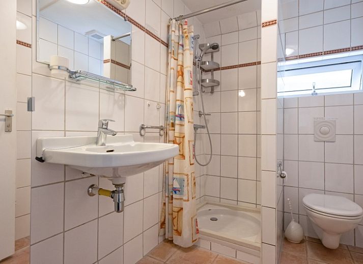 Cozy living room of Holiday home Slufterduin 108 in De Cocksdorp Texel, perfect for relaxation on the Wadden Islands.