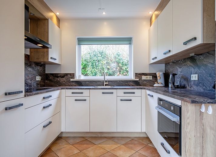 Gemuetliches Wohnzimmer des Ferienhauses Slufterduin 134 in De Cocksdorp Texel mit bequemer Sitzecke.