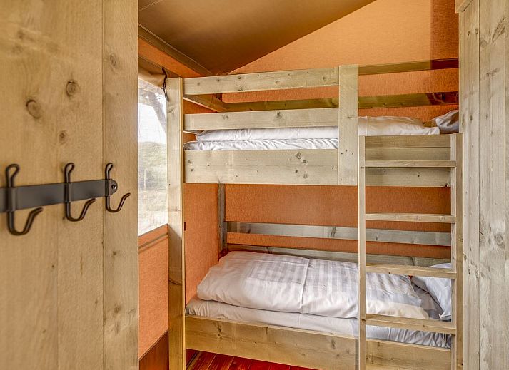 Spacious living room in Sluftervallei glamping lodge, Texel, overlooking nature.