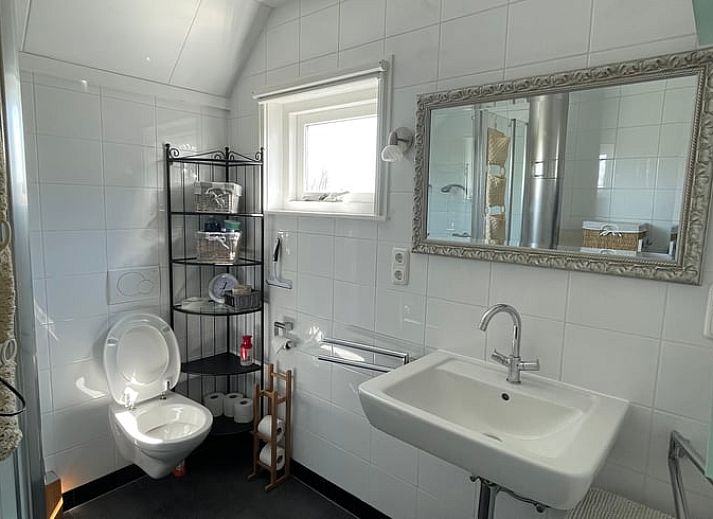 Outdoor dining overlooking the garden at Holiday home in De Cocksdorp, Texel, Wadden Islands.