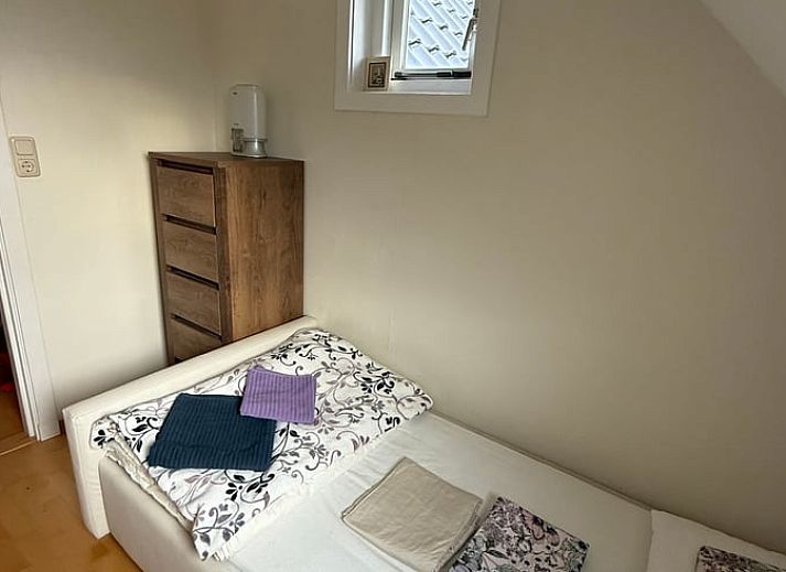 Cozy indoor space with wooden furniture in Holiday home in De Cocksdorp, Texel, Wadden Islands.