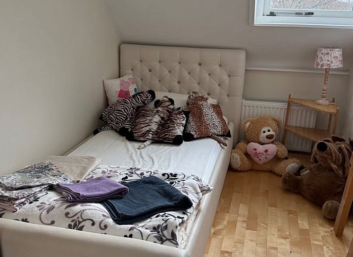 Cozy indoor space with wooden furniture in Holiday home in De Cocksdorp, Texel, Wadden Islands.