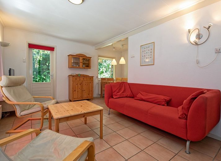 Vacation home Slufterduin 088 in De Cocksdorp, Texel, surrounded by green nature and an inviting terrace.