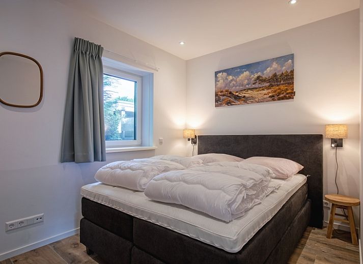 Gezellige woonkamer in Vakantiehuis Slufterhoek 104, De Cocksdorp Texel, met comfortabele zitruimte en sfeervolle inrichting.