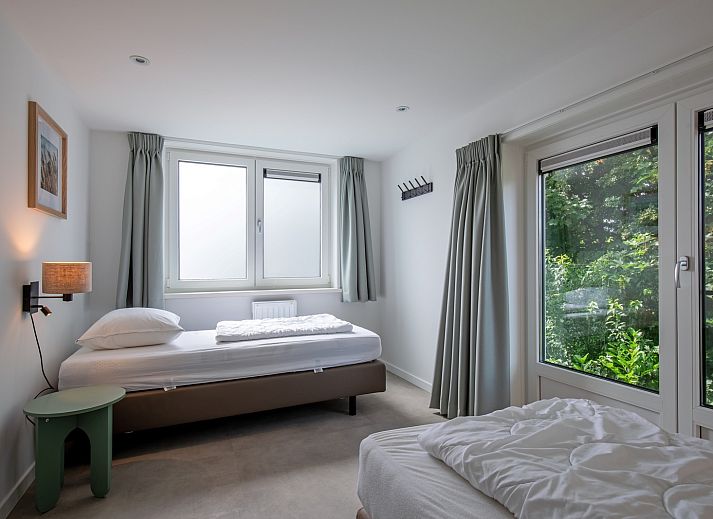 Gezellige woonkamer in Vakantiehuis Slufterhoek 104, De Cocksdorp Texel, met comfortabele zitruimte en sfeervolle inrichting.