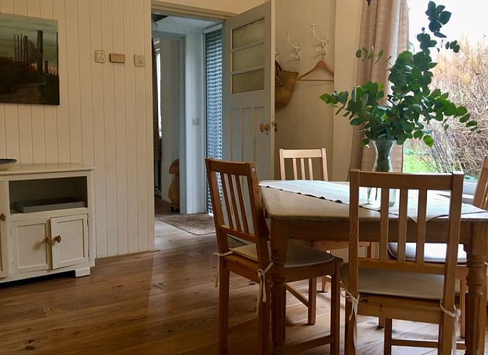 Cozy terrace at Cottage in De Cocksdorp, Texel, surrounded by greenery and tranquility.