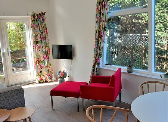 Modern kitchen in vacation home Huisje Quirijn, De Koog Texel with wooden cabinets and light through skylight.