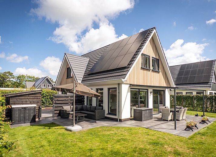 Stylish living room of Villa 41 in De Koog, Texel, with modern decor and lots of natural light.