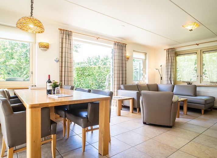 Cozy living room in Villa, De Koog, Texel with comfortable seating area and lots of natural light.