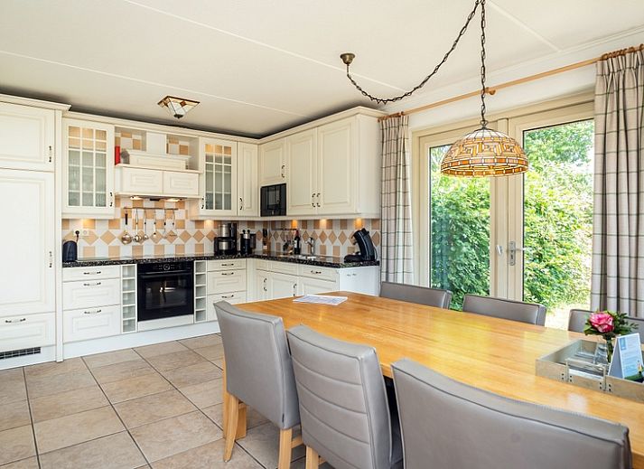 Cozy living room in Villa, De Koog, Texel with comfortable seating area and lots of natural light.