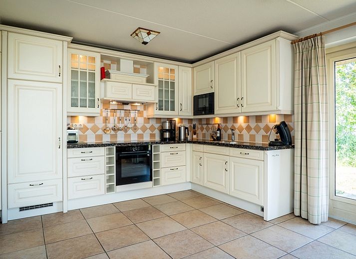 Cozy living room in Villa, De Koog, Texel with comfortable seating area and lots of natural light.