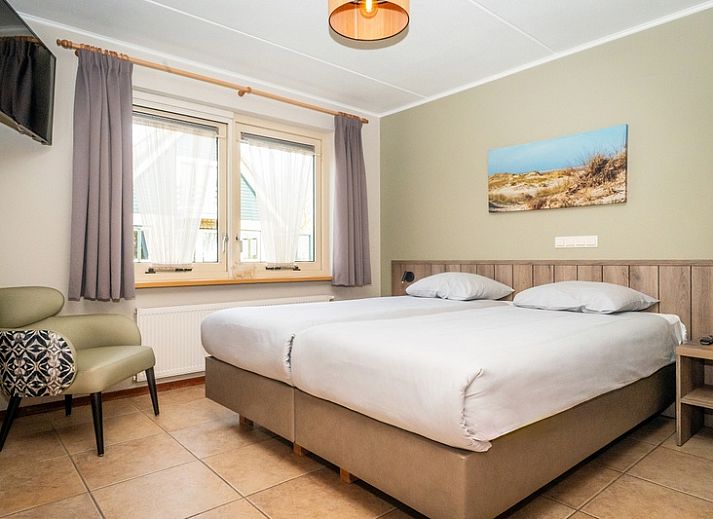 Cozy living room in Villa, De Koog, Texel with comfortable seating area and lots of natural light.