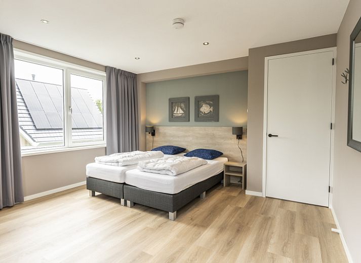 Villa 17 in De Koog, Texel offers a spacious terrace with modern garden furniture and green surroundings for a relaxing vacation.