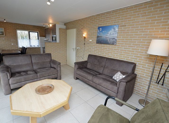 Vacation home Stappeland 213 in De Koog, Texel offers a charming exterior with green hedges and quiet street in the Wadden Islands.