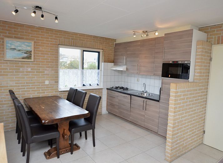 Vacation home Stappeland 213 in De Koog, Texel offers a charming exterior with green hedges and quiet street in the Wadden Islands.