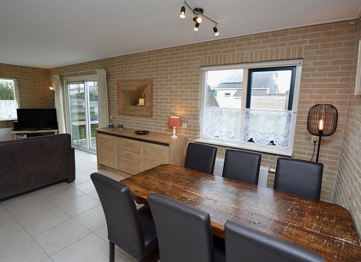 Cozy living room in Holiday home Stappeland 213, De Koog, Texel with comfortable seating area and garden view.