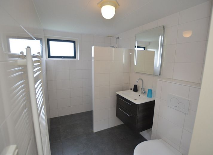 Cozy living room in Holiday home Stappeland 213, De Koog, Texel with comfortable seating area and garden view.