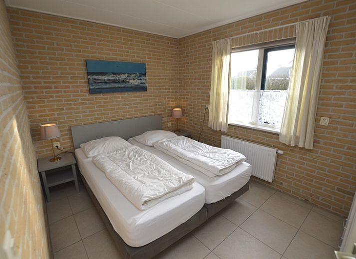 Cozy living room in Holiday home Stappeland 213, De Koog, Texel with comfortable seating area and garden view.
