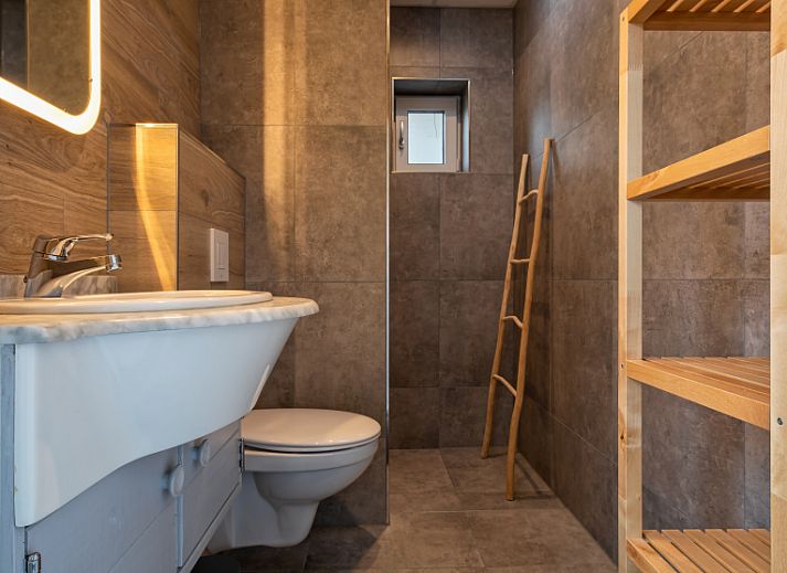 Bright interior space in Riddertje vacation home, De Koog, Texel. Enjoy the natural light and views.