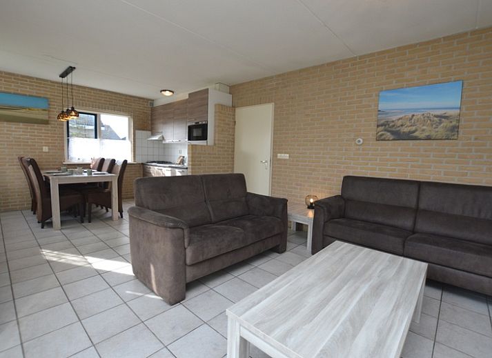 Vacation home Stappeland 207 in De Koog, Texel offers a charming exterior surrounded by greenery, ideal for a relaxing stay.