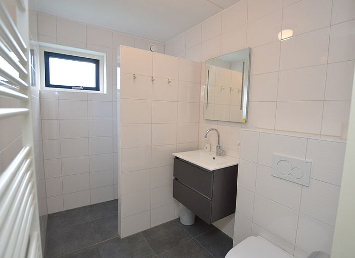 Cozy living room in Holiday home Stappeland 207, De Koog, Texel with comfortable sofas and lots of natural light.