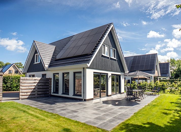 Villa 39 in De Koog, Texel, offers a spacious terrace with modern outdoor space for relaxation on the Wadden Islands.