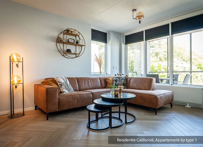 Cozy living room in Type 1 vacation home, De Koog, Texel with comfortable sofa and lots of natural light.