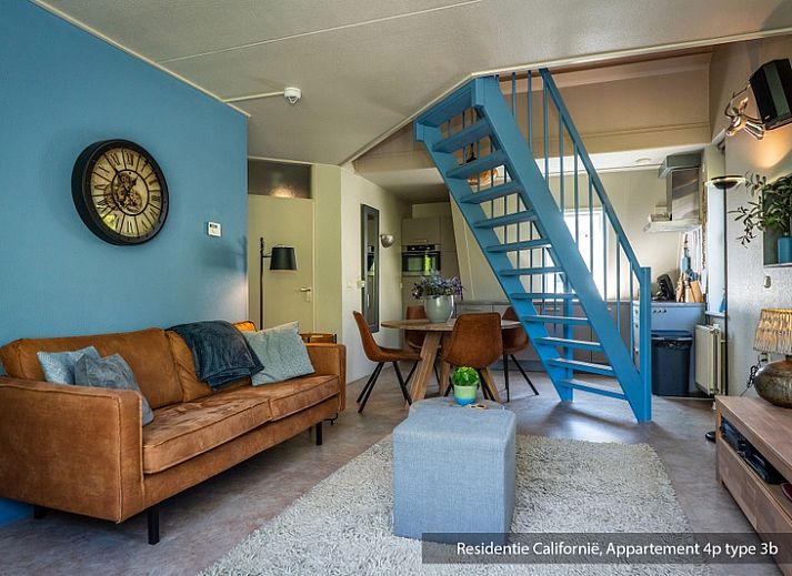 Cozy living room in Type 3B vacation home in De Koog, Texel with comfortable seating area and lots of natural light.