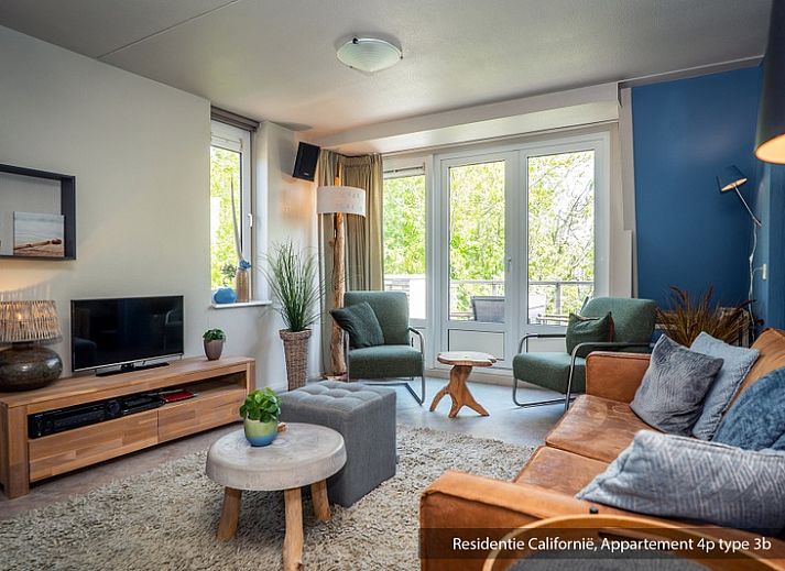 Cozy living room in Type 3B vacation home in De Koog, Texel with comfortable seating area and lots of natural light.