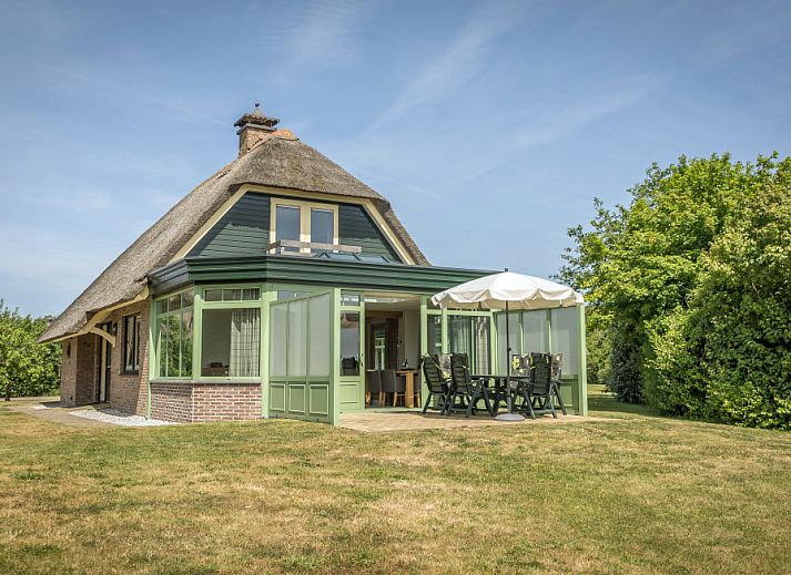 Villa with Conservatory in De Koog, Texel with charming exterior and green surroundings.
