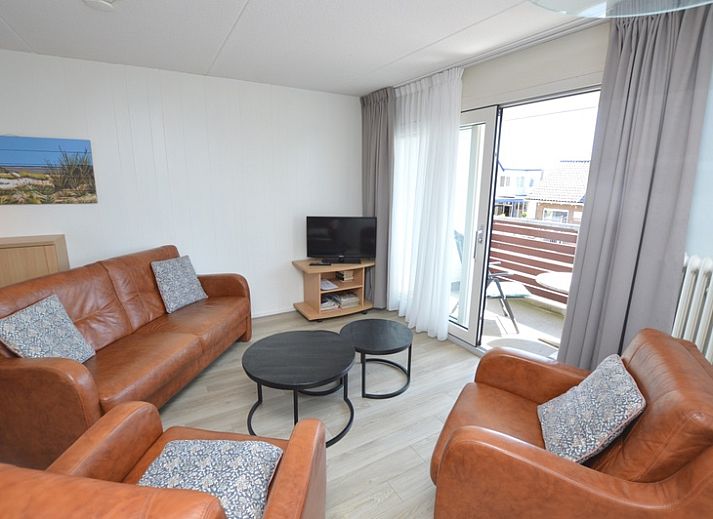 Gemuetliche Sitzecke im Motel Texel - Apartment 208/1L, De Koog, Texel, mit bequemen Ledersofas und einer offenen Kueche.