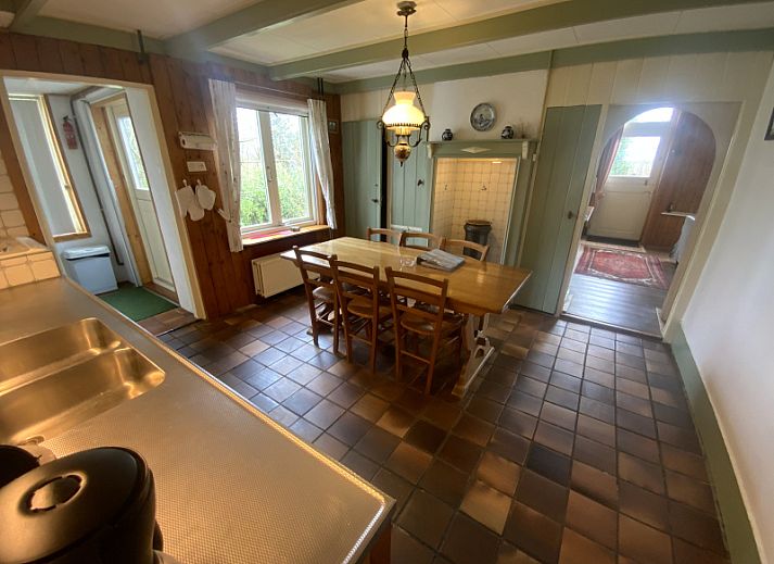 Front house vacation home in De Koog Texel with traditional facade and green shutters.