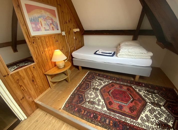 Cozy terrace at Voorhuis vacation home in De Koog Texel surrounded by greenery.