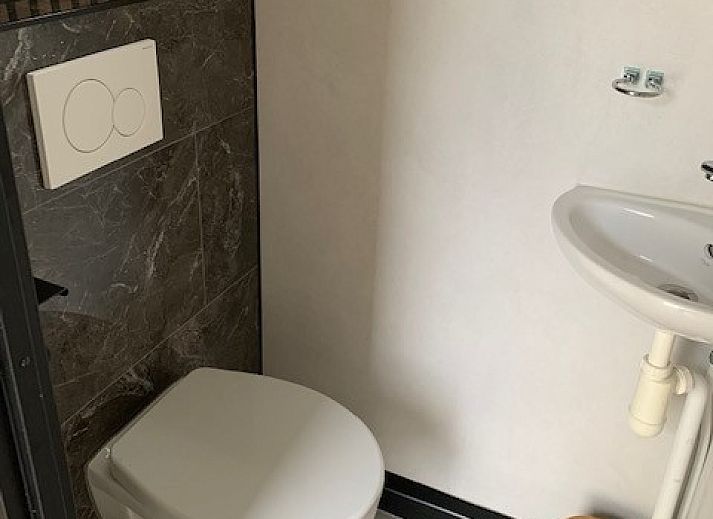 Vacation home Chalet Bregkoog 203, located in De Koog, Texel, with spacious driveway and green surroundings.