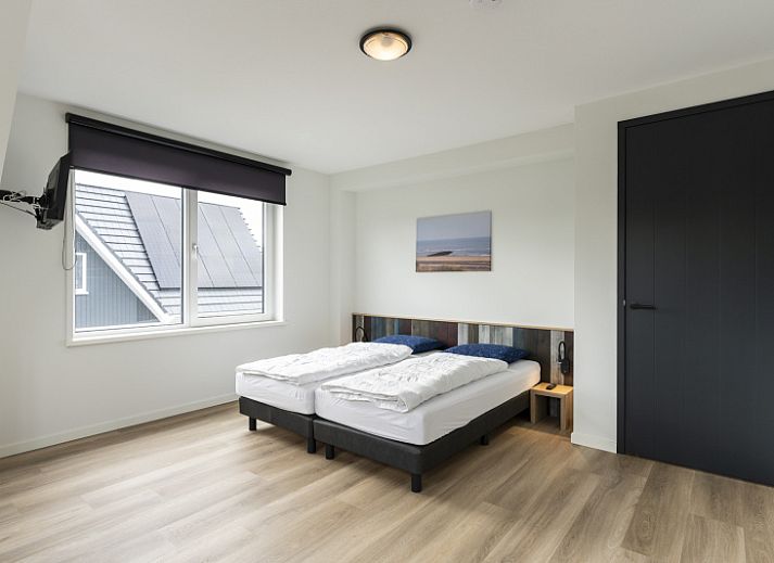 Modern living room of Villa 37, De Koog, Texel. Comfortable seating area in vacation home on the Wadden Islands.