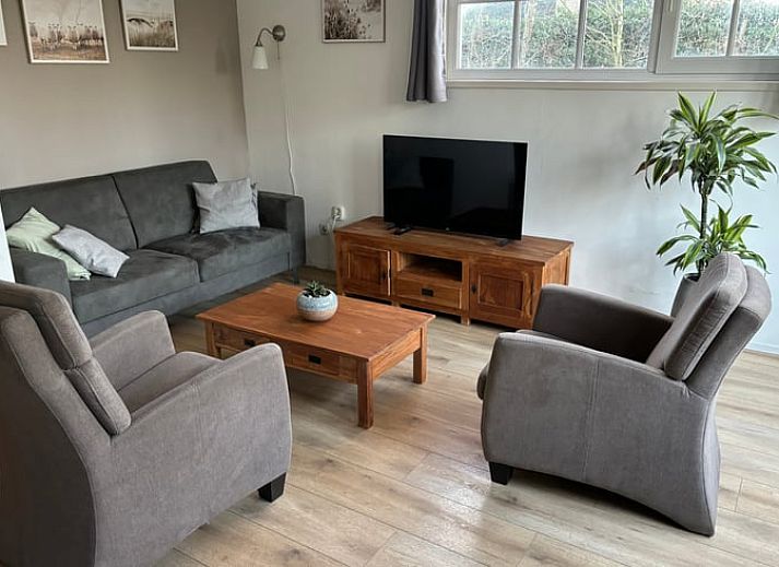 Enjoy the sunny patio at Cottage in De Koog, Texel, with comfortable outdoor furniture and green surroundings.