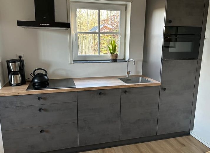 Enjoy the sunny patio at Cottage in De Koog, Texel, with comfortable outdoor furniture and green surroundings.