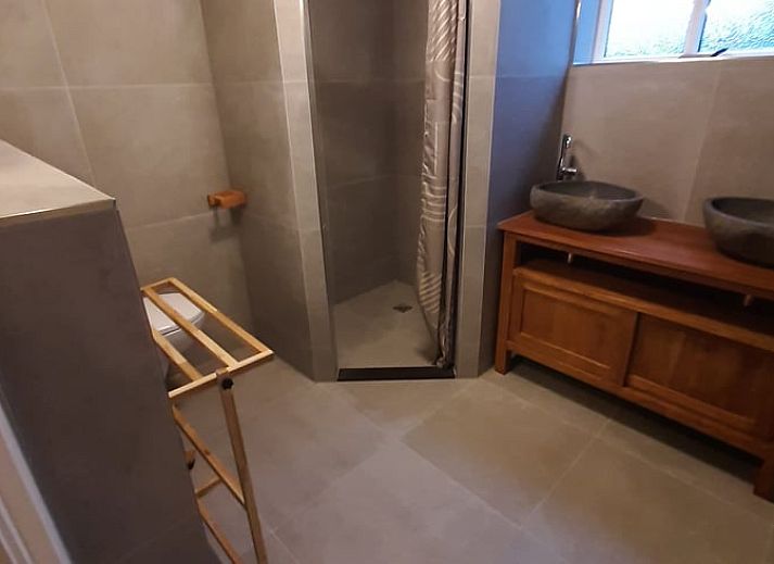 Exterior of vacation home Cottage in De Koog, Texel, with charming bricks and modern windows.