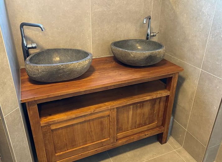 Exterior of vacation home Cottage in De Koog, Texel, with charming bricks and modern windows.