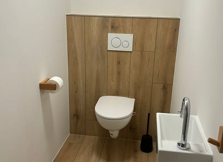 Exterior of vacation home Cottage in De Koog, Texel, with charming bricks and modern windows.