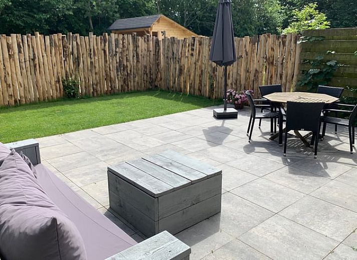 Exterior of vacation home Cottage in De Koog, Texel, with charming bricks and modern windows.