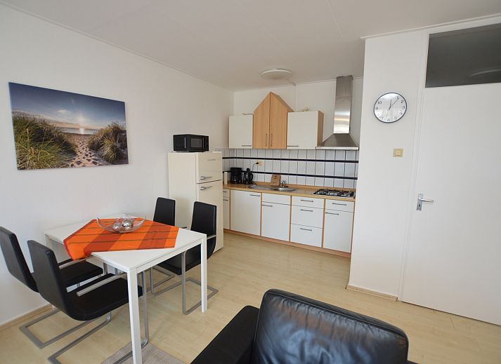 Stylish interior space of Apartment Kerckeland 98, De Koog, Texel with dining and sitting area for a relaxing stay.