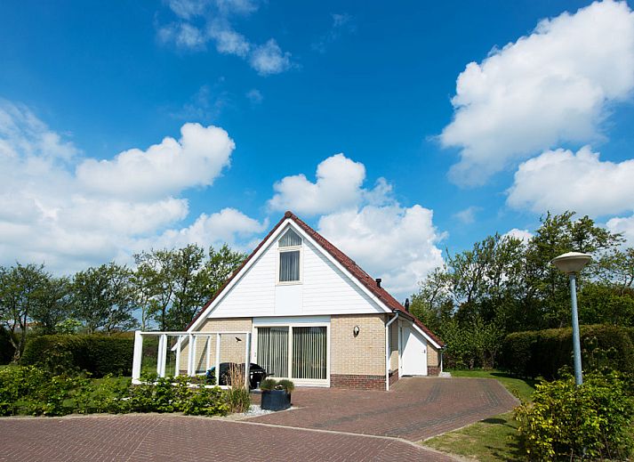 Villa 5 in De Koog, Texel, offers a charming vacation home with a beautiful garden and an inviting veranda.