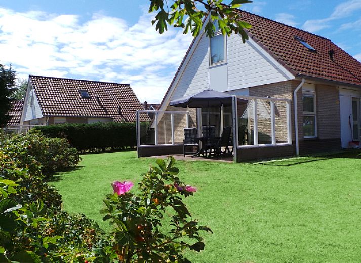 Villa 5 in De Koog, Texel, offers a charming vacation home with a beautiful garden and an inviting veranda.