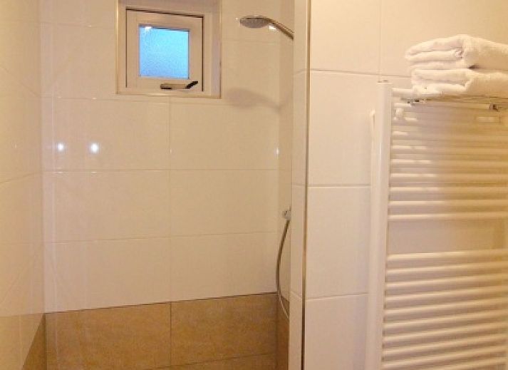 Spacious garden at D' Duinster vacation home in De Koog, Texel, surrounded by greenery on the Wadden Islands.