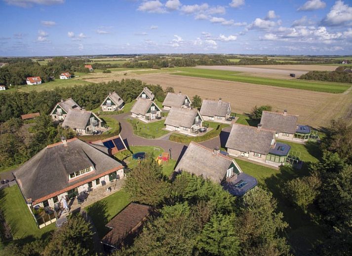 Cozy living room in 6 Person luxury villa with sauna, De Koog, Texel. Comfortable sitting area with fireplace and modern amenities.