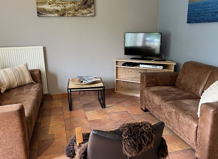 Coach house vacation home in De Koog, Texel, with a charming terrace and green surroundings on the Wadden Islands.