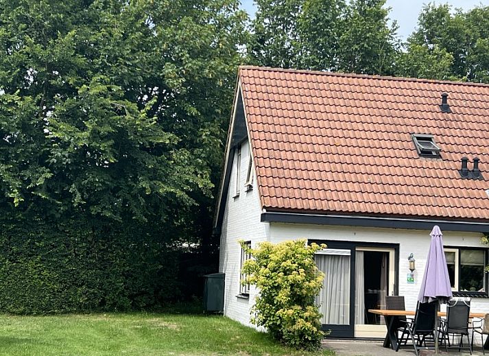 Cozy living room of Koetshuis vacation home in De Koog, Texel, with comfortable sofas and a television for relaxation.