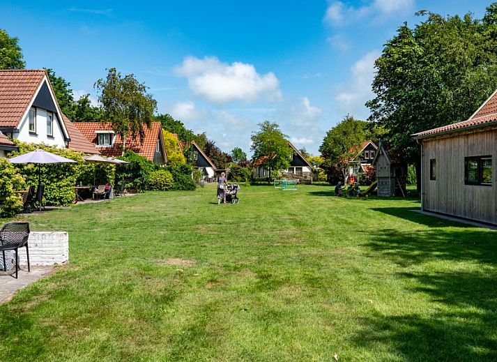 Cozy living room of Koetshuis vacation home in De Koog, Texel, with comfortable sofas and warm decor on the Wadden Islands.